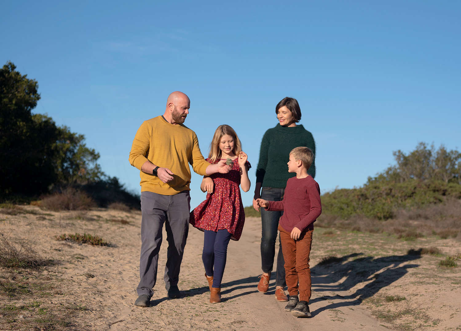 Family walking on a scenic trail in Marin during a relaxed outdoor portrait session