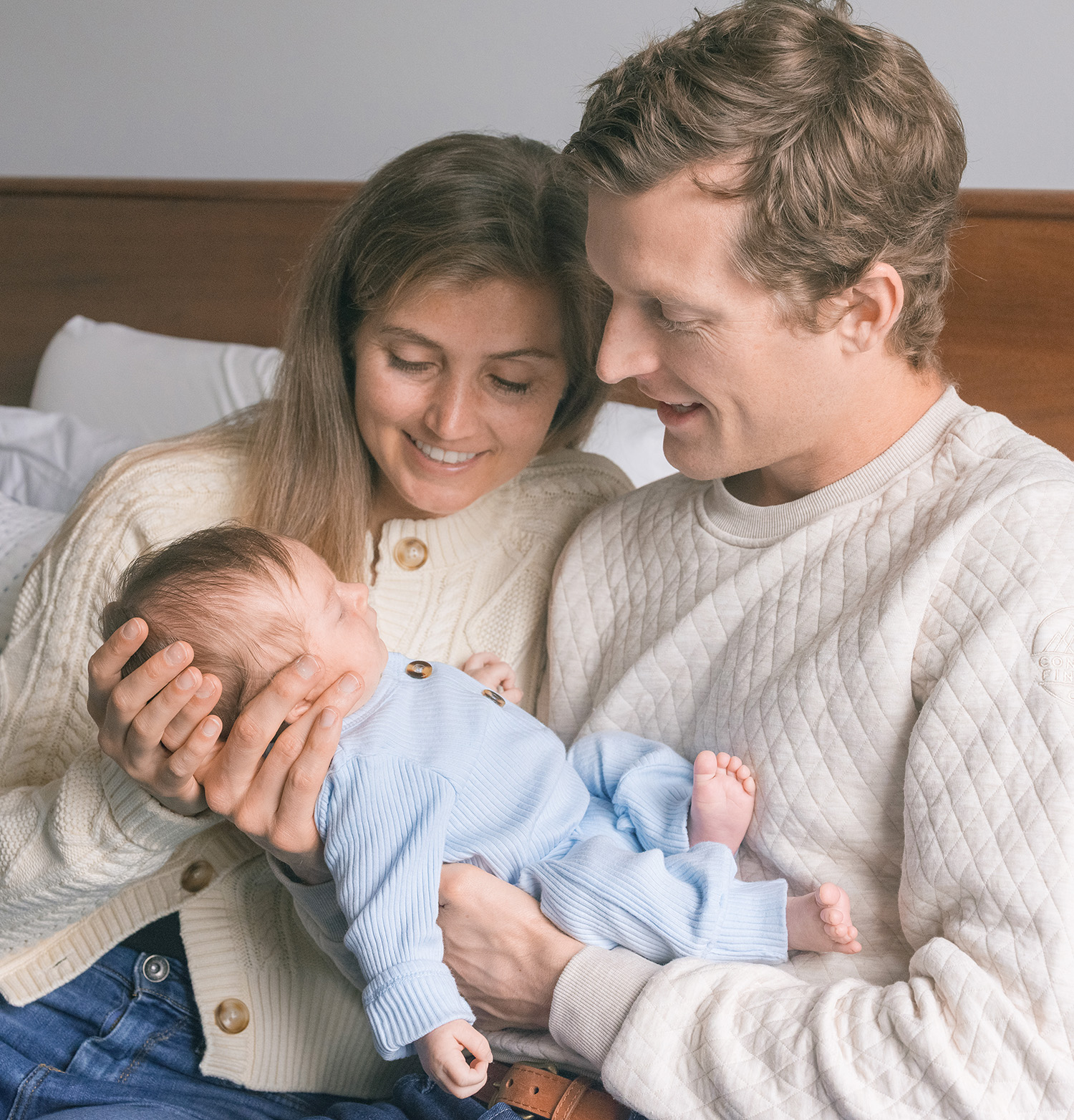 San Francisco lifestyle newborn photography featuring parents holding their baby in their Marina home